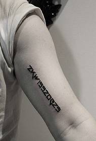 The simple English word tattoo picture on the inside of the arm
