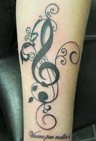 good-looking musical notes on the arm of the vine tattoo