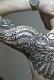 male arm creative wing tattoo modely