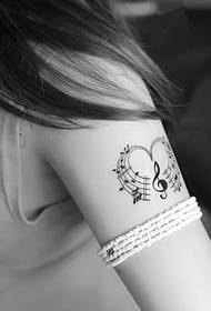 beautiful black and white heart-shaped notes tattoo