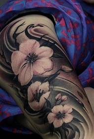 female flower has three flower tattoos on the arm