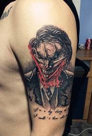 Evil portrait and English combined arm tattoo