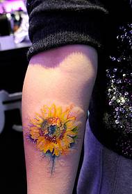 a sunflower tattoo that falls on the arm